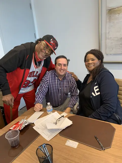 Michael Muzquiz of Property Problem Solvers at a closing with happy sellers